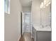 Bathroom featuring a vanity with gray cabinets and a view into the hallway at 83 Arnold Poplar Ln, Auburn, GA 30011