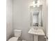 Bathroom featuring a pedestal sink, a large mirror, and modern lighting at 83 Arnold Poplar Ln, Auburn, GA 30011