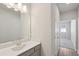 Bright bathroom featuring a modern vanity with gray cabinets and a large mirror with contemporary lighting at 83 Arnold Poplar Ln, Auburn, GA 30011