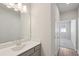 Bright bathroom featuring a single vanity, a mirror and tile flooring at 83 Arnold Poplar Ln, Auburn, GA 30011