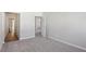 Spacious carpeted bedroom with open doorways to other rooms, offering a bright, airy feel at 83 Arnold Poplar Ln, Auburn, GA 30011