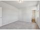 Bedroom with light gray walls featuring a large carpeted space at 83 Arnold Poplar Ln, Auburn, GA 30011