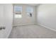 Clean, bright bedroom with two windows, carpeted floor, and neutral walls at 83 Arnold Poplar Ln, Auburn, GA 30011