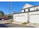 A well-lit two car garage featuring white doors in a townhome community at 83 Arnold Poplar Ln, Auburn, GA 30011