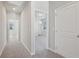 Carpeted hallway leading to bedrooms with natural light, showing a home's layout at 83 Arnold Poplar Ln, Auburn, GA 30011