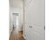 Hallway with wood-look flooring and closet doors, leading to a bathroom in the distance at 83 Arnold Poplar Ln, Auburn, GA 30011