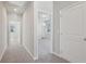 Carpeted hallway with multiple doorways showcasing the home's layout and natural light at 83 Arnold Poplar Ln, Auburn, GA 30011