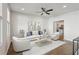 Bright and airy living room with modern furnishings and a view into the open-concept kitchen space at 83 Arnold Poplar Ln, Auburn, GA 30011