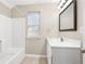 Bathroom featuring a shower-tub combo, ceramic tile floor, and single sink vanity at 1477 Akridge Nw St, Atlanta, GA 30314
