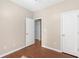 Bedroom featuring hardwood floors, neutral paint, and two entryways at 1477 Akridge Nw St, Atlanta, GA 30314