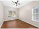 Bedroom with wood-look floors, ceiling fan, and two bright windows at 1477 Akridge Nw St, Atlanta, GA 30314