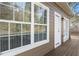 Back exterior view shows windows, a door to deck, and vinyl siding at 1477 Akridge Nw St, Atlanta, GA 30314