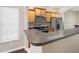 Well-lit kitchen with stainless steel appliances and a granite-topped breakfast bar at 1477 Akridge Nw St, Atlanta, GA 30314