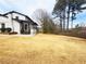 Expansive backyard featuring a screened-in porch and mature trees, offering privacy and space for outdoor activities at 2167 Cedar Dr, Lawrenceville, GA 30043