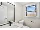 Modern bathroom with a sleek mirror, black hardware, and natural light from the window at 2167 Cedar Dr, Lawrenceville, GA 30043