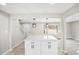 Bright, open kitchen area featuring white cabinets, a quartz island, and modern light fixtures at 2167 Cedar Dr, Lawrenceville, GA 30043