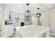 Modern kitchen with white cabinets, stainless steel appliances, and a quartz island at 2167 Cedar Dr, Lawrenceville, GA 30043