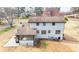 Two story home featuring a rear exterior with an enclosed porch and a large backyard at 2167 Cedar Dr, Lawrenceville, GA 30043