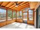 Inviting sunroom with wood paneling, large windows, and plenty of natural light at 2167 Cedar Dr, Lawrenceville, GA 30043