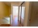 Hallway featuring laminate flooring, closet, and access to rooms with natural light at 2173 Wellington Cir, Lithonia, GA 30058