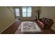 Comfortable living room with wood floors and ample natural light from large windows at 2173 Wellington Cir, Lithonia, GA 30058