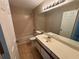 Bathroom featuring a single sink vanity and a shower-tub combo with tile surround at 406 Hawkstone Way, Alpharetta, GA 30022