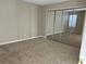 Bedroom with mirrored closet doors and neutral wall-to-wall carpet at 406 Hawkstone Way, Alpharetta, GA 30022