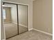 Bedroom with mirrored closet doors, neutral walls, carpet, and a ceiling fan at 406 Hawkstone Way, Alpharetta, GA 30022