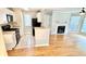 Well-lit kitchen with granite countertops, white cabinets, and hardwood floors at 406 Hawkstone Way, Alpharetta, GA 30022