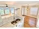 Open floor plan view of the living and dining area featuring hardwood floors and natural light at 406 Hawkstone Way, Alpharetta, GA 30022