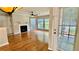 Bright living room with hardwood floors, fireplace, and multiple windows at 406 Hawkstone Way, Alpharetta, GA 30022