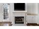 Close up of fireplace with white mantel, mounted tv, and french doors in living room at 850 Piedmont Ne Ave # 1302, Atlanta, GA 30308