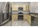 Kitchen with stainless steel appliances, granite countertops, and stone tile flooring at 850 Piedmont Ne Ave # 1302, Atlanta, GA 30308