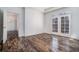 Light room featuring hardwood floors and French doors leading to a balcony at 850 Piedmont Ne Ave # 1302, Atlanta, GA 30308