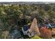Aerial view of a landscaped property in a wooded area with city skyline in the background at 993 Northrope Ne Dr, Atlanta, GA 30324