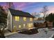 Back of house featuring patio, landscaped yard, and outdoor fire pit at dusk at 993 Northrope Ne Dr, Atlanta, GA 30324