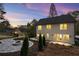 Back of house featuring patio, landscaped yard, and outdoor fire pit at dusk at 993 Northrope Ne Dr, Atlanta, GA 30324