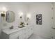 Bright bathroom features double vanity with marble countertops, modern fixtures, and decorative mirrors at 993 Northrope Ne Dr, Atlanta, GA 30324