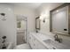 Modern bathroom featuring double vanity with marble countertop and white tile shower at 993 Northrope Ne Dr, Atlanta, GA 30324