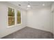 Bright, carpeted bedroom with ceiling fan, and windows with backyard views at 993 Northrope Ne Dr, Atlanta, GA 30324