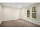 Bright, carpeted bedroom with ceiling fan, crown molding, and windows with backyard views at 993 Northrope Ne Dr, Atlanta, GA 30324