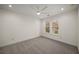 Bright bedroom with neutral carpet, ceiling fan, and windows overlooking a green yard at 993 Northrope Ne Dr, Atlanta, GA 30324