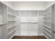 Walk-in closet with wood floors and built-in white shelving at 993 Northrope Ne Dr, Atlanta, GA 30324