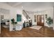 Gracious foyer with hardwood floors, a modern chandelier, a staircase, and an inviting view into the living spaces at 993 Northrope Ne Dr, Atlanta, GA 30324