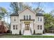 Charming two-story home featuring a painted brick facade, gable roof, and inviting front porch at 993 Northrope Ne Dr, Atlanta, GA 30324