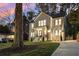 Lovely two-story home with a manicured lawn, a mature tree, and a long driveway at 993 Northrope Ne Dr, Atlanta, GA 30324