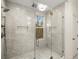 Modern shower with frameless glass enclosure, gray tile surround, and stylish tile floor at 993 Northrope Ne Dr, Atlanta, GA 30324