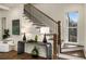 Elegant staircase with dark wood rails, white risers, and a modern console table adorned with decorative accents at 993 Northrope Ne Dr, Atlanta, GA 30324