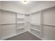 Walk-in closet with custom shelving, and carpeted floor at 993 Northrope Ne Dr, Atlanta, GA 30324