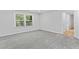 Large bedroom with window and plush gray carpet at 2023 Stoneleigh Dr, Stone Mountain, GA 30087